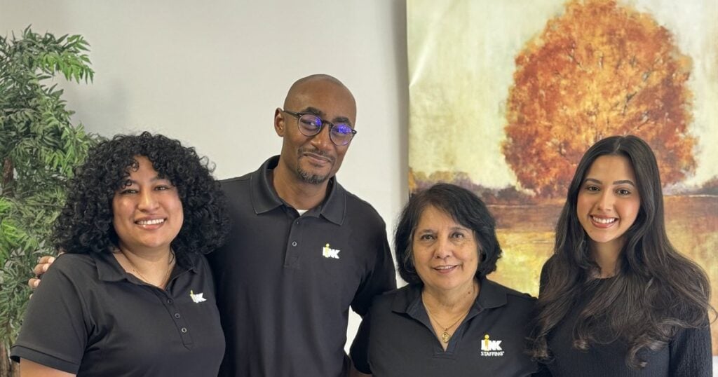 Donald Jones and the LINK Staffing Irving team together in the office.